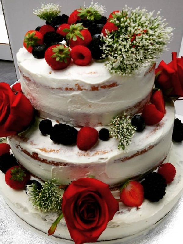 Torta a tre piani con glassa bianca e rose rosse Crave Food Bakery Udine